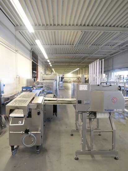 Tramper filling- and traysealing line